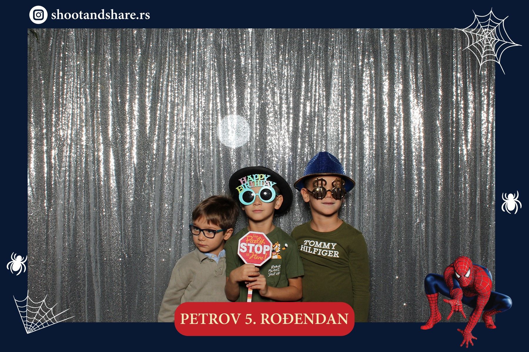 Boys at a birthday party in front of the silver sequin backdrop